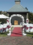 Decorated arch in aisle garden wedding